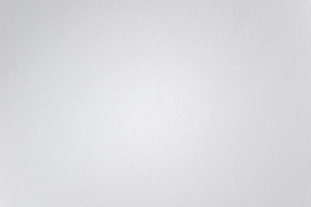 Subtle texture of a clean white wall, perfect for minimal designs.